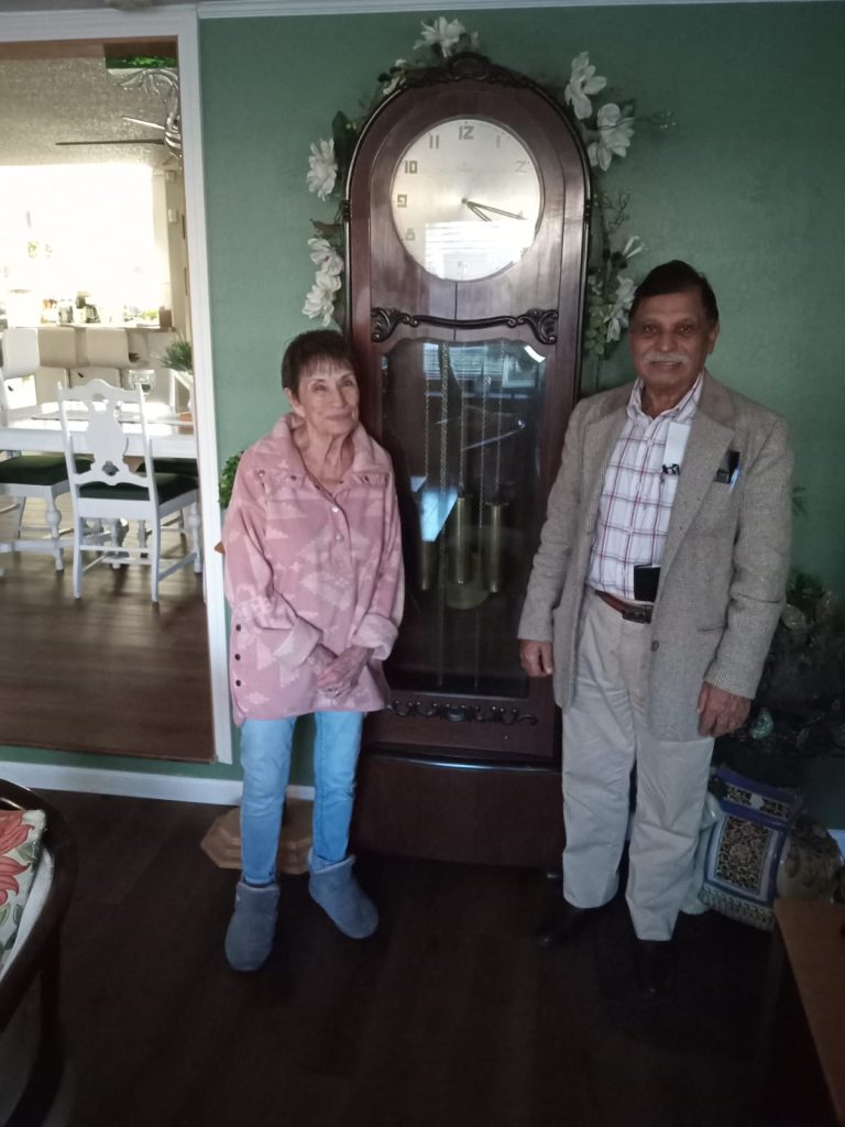 In-home grandfather clock repair with a customer